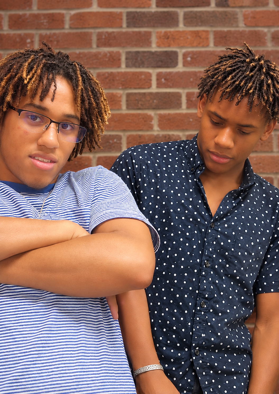 Two clients with Brother Locs, honey-blonde and caramel-highlighted tips